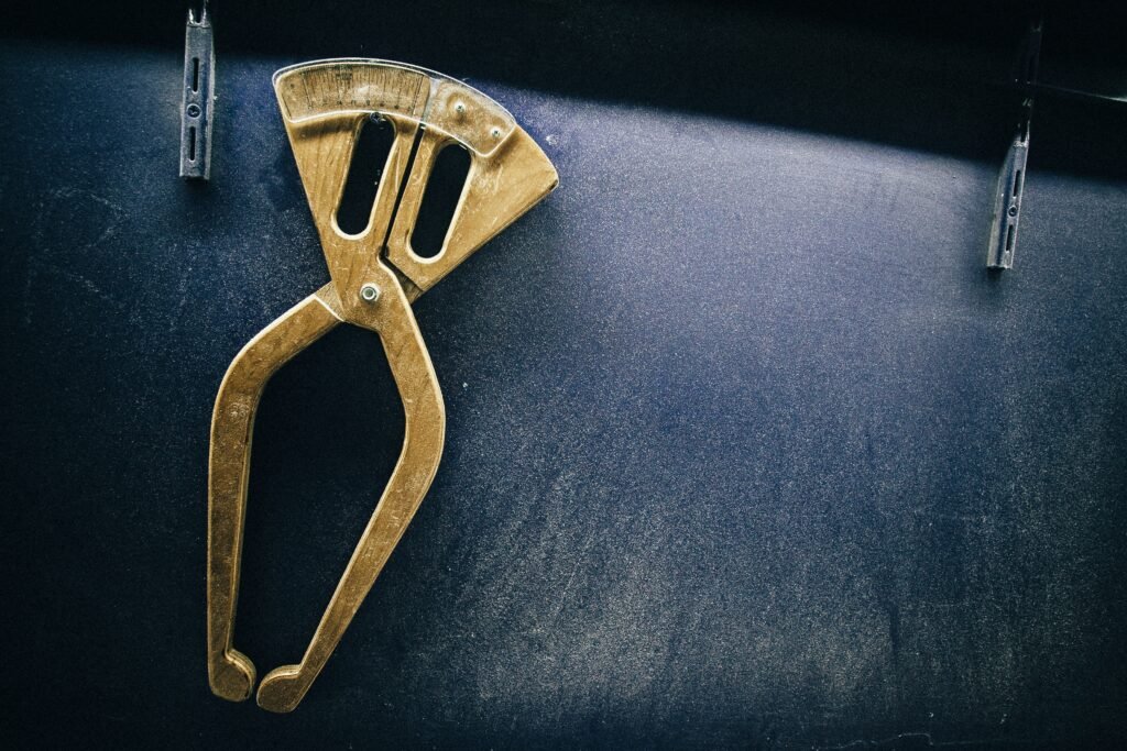 closeup shot of a scissor compass hanging on a shelf